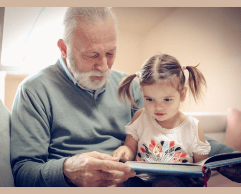 an elderly gentleman reading to a young girl