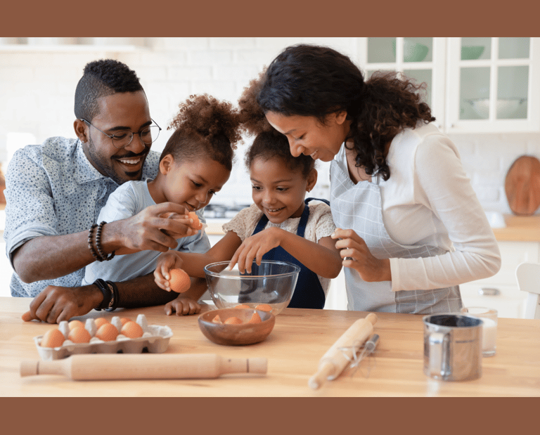 a family breaking eggs as they prepare food together