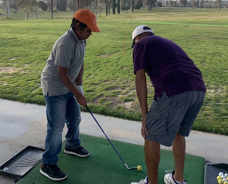 Enhancing Forward Action Inc. image young golfer being taught golf