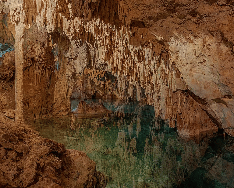 Magical cenote cave with turquoise water and dramatic stalactites in Tulum, Mexico – sacred space fo