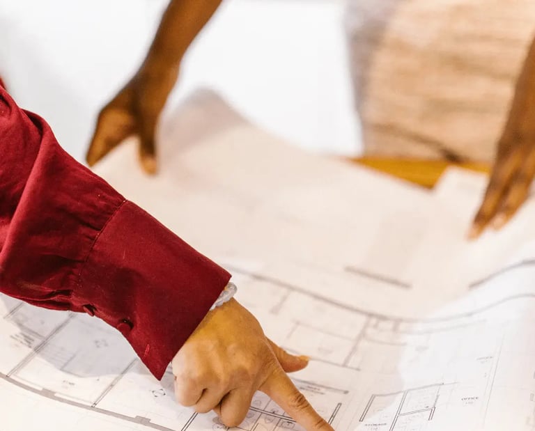 Home buyers reviewing a detailed floor plan before purchase