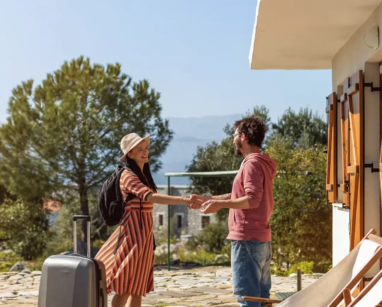 Host welcoming a guest at a vacation rental, enhancing Airbnb and VRBO listings