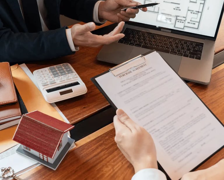 Home buyers reviewing a floor plan and contract