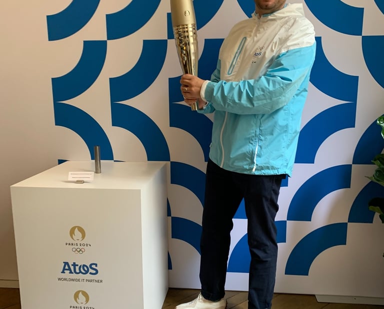 Tim Dougill holding the Paris24 Olympic torch.