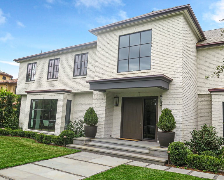 a white house with a large front door and a large front door