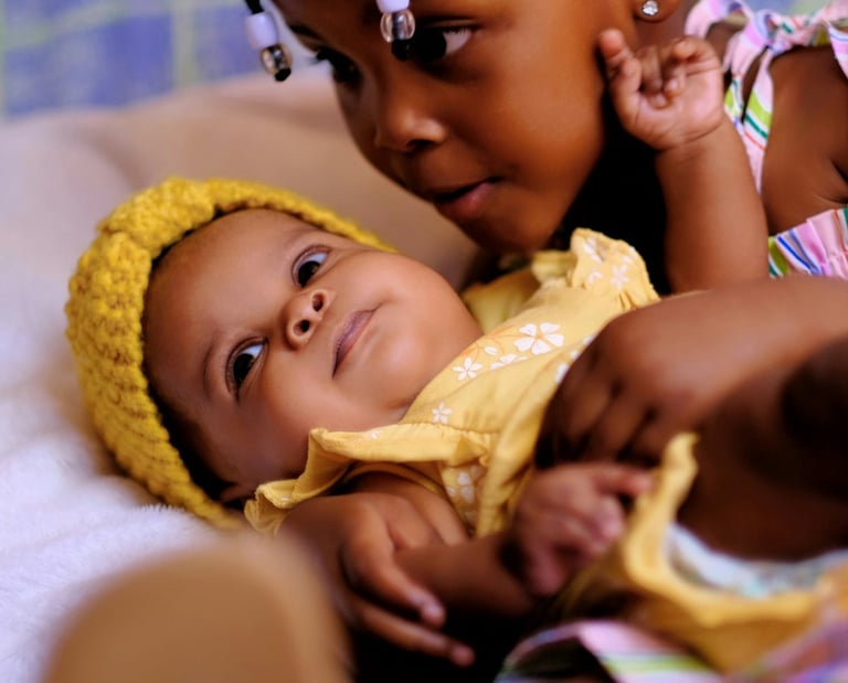 a baby girl in a yellow dress and a yellow hat