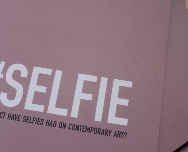 a pink book, the cover says '#Selfie: What impact have selfies had on contemporary art?'