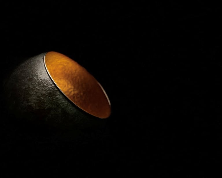 a black and gold bowl with a gold rim