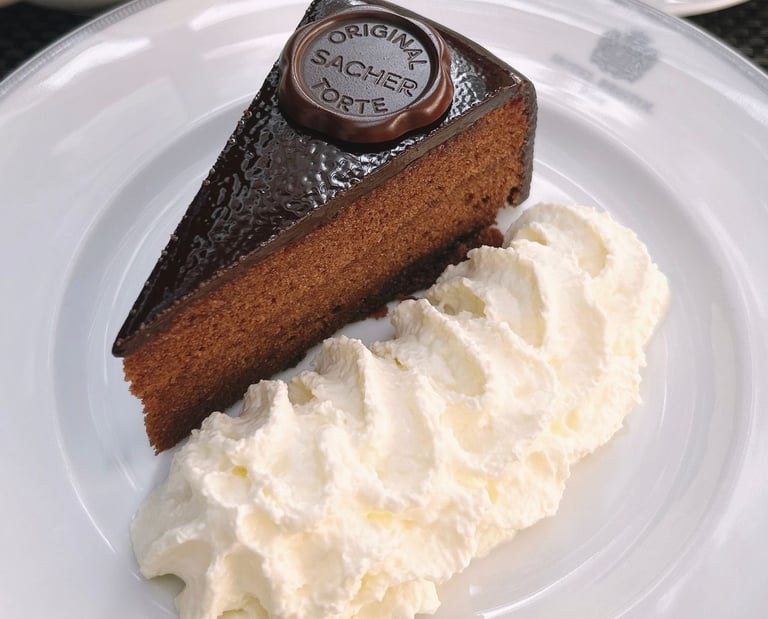 Porción de la auténtica tarta Sacher con su brillante cobertura y sello oficial de chocolate