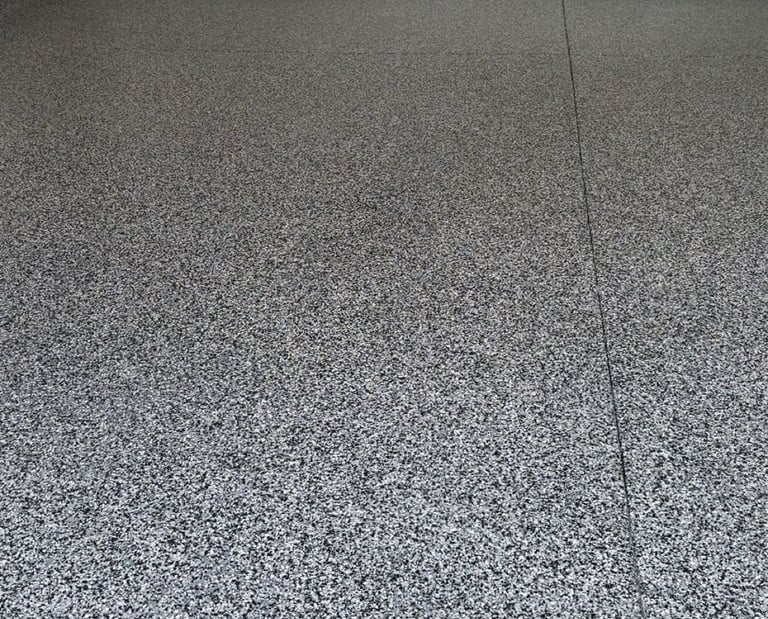 After of Home garage with domino flake floor in Grand Island home.