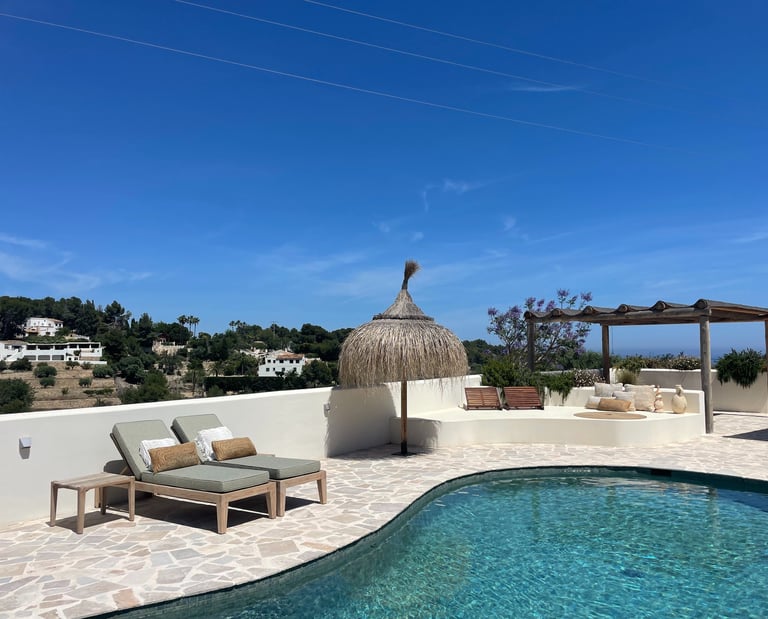 Luxury Mediterranean villa with pool and lounging area representing premium coaching experience