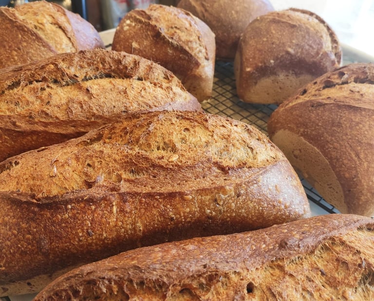 a bunch of breaded breads on a cooling rack