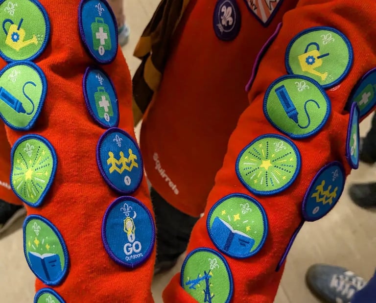 Two Squirrels show their many badges from the 25th Allerton Scout group