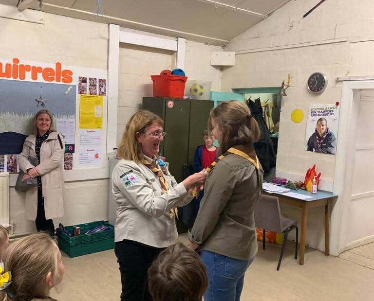 A young leader is invested in Scouts in Grassendale