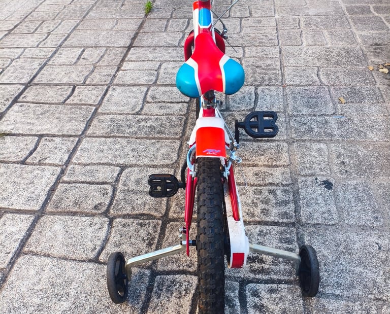Dino Bikes 14 polegadas vista frontal com rodas de apoio e pedais