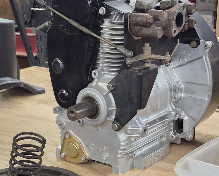 newly rebuilt engine sitting on a wooden bench in a small engine shop