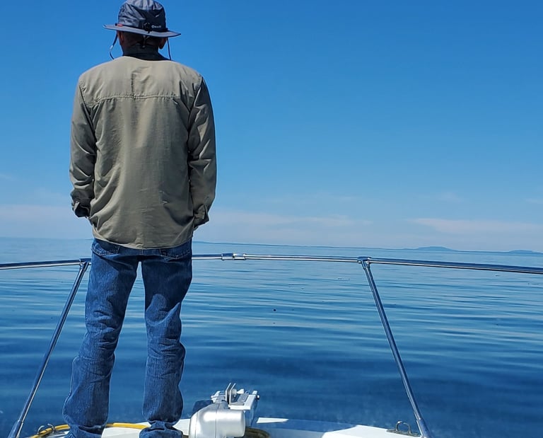 a man standing on a boat in the ocean