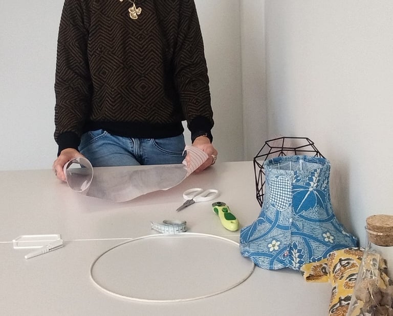 a woman sitting at a table with a paper bag