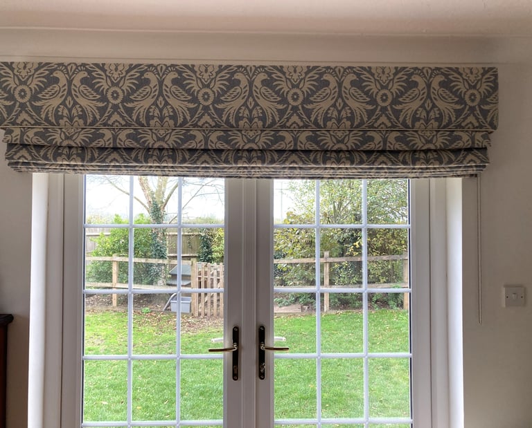 A large blind with a solid fabric in the same fabric which is carefully pattern matched