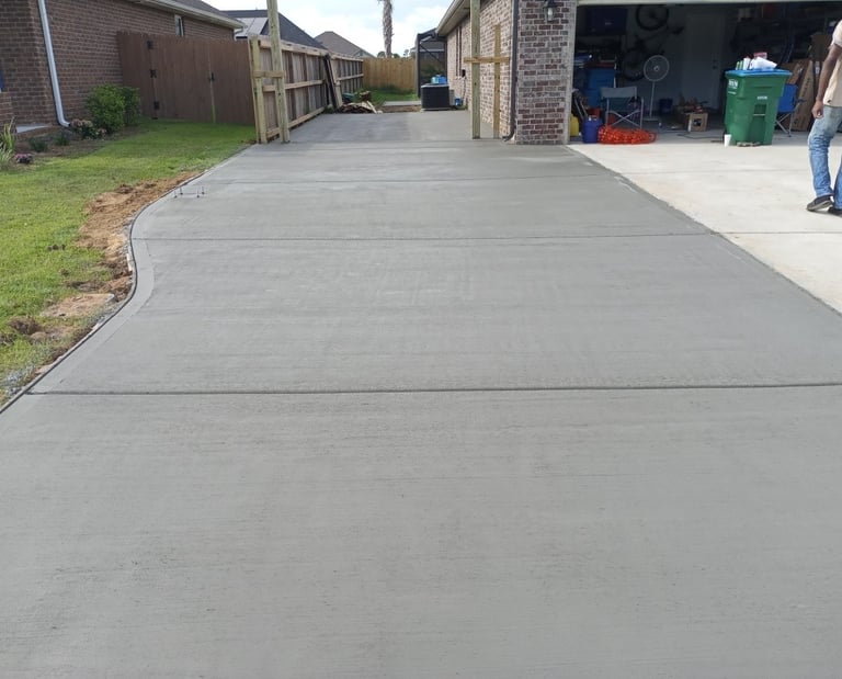 Newly poured concrete driveway in Navarre FL with smooth, clean finish by local concrete contractor