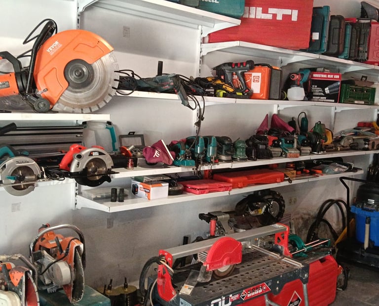 Organized workshop shelving featuring power tools, concrete saws, and tile cutters from brands like Vevor and Makita.