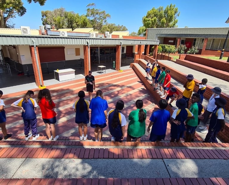 a group of children and adults standing in a line learning life skills