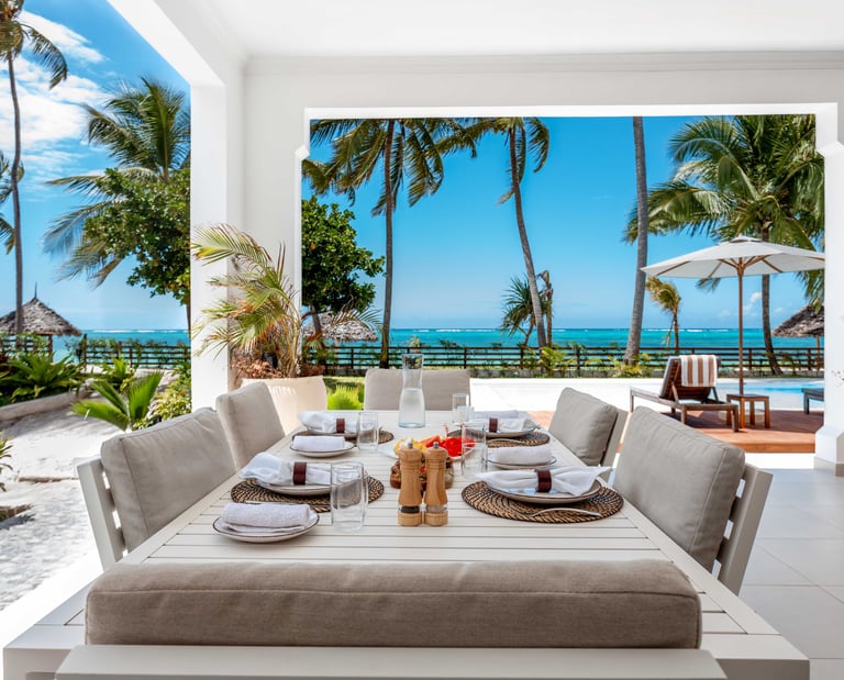 a table setting eight with a ocean view at Villa Serene Zanzibar