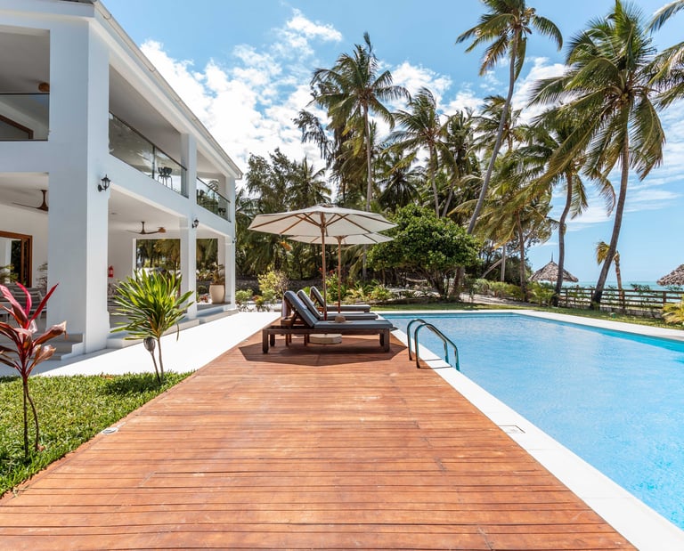 a wooden deck with lounge chairs and umbrellas