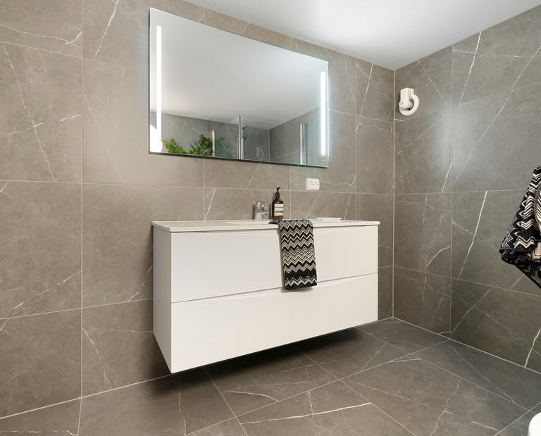 a bathroom with a white sink and a mirror