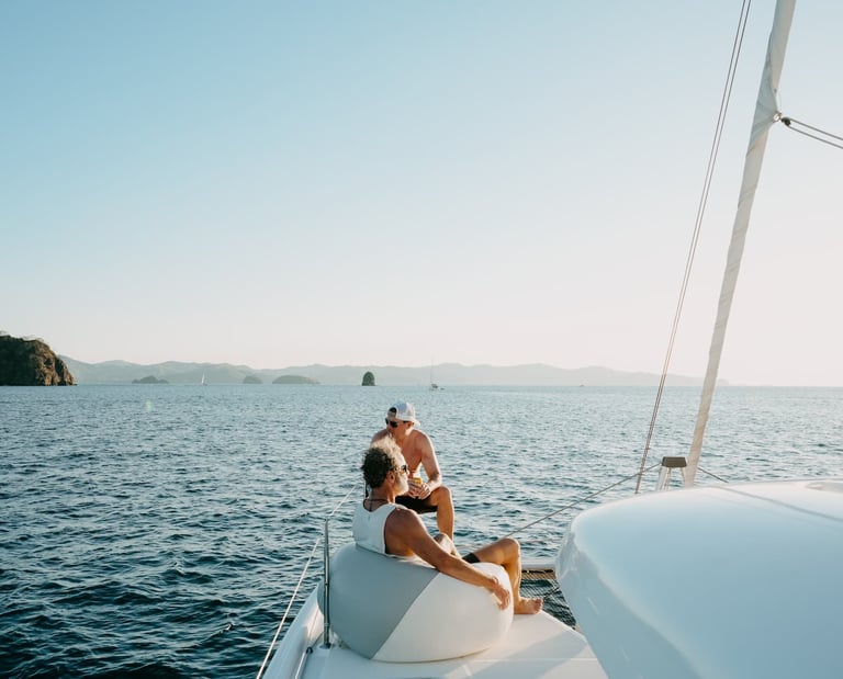 Couple relaxing on the bow of private luxury catamaran in Guanacaste, Costa Rica