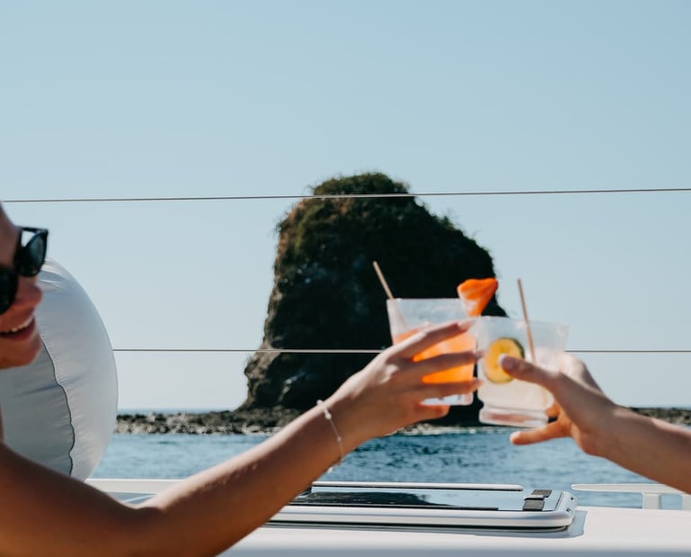 Guests enjoying premium cocktails toast onboard private catamaran in Papagayo Gulf