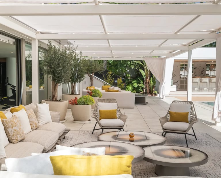 Shaded poolside sofas and lounge area at Villa Serenity Marbella