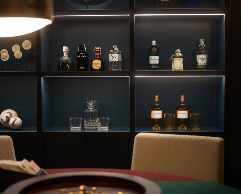 Cigar lounge at Villa La Gratitud with backlit shelves and roulette table