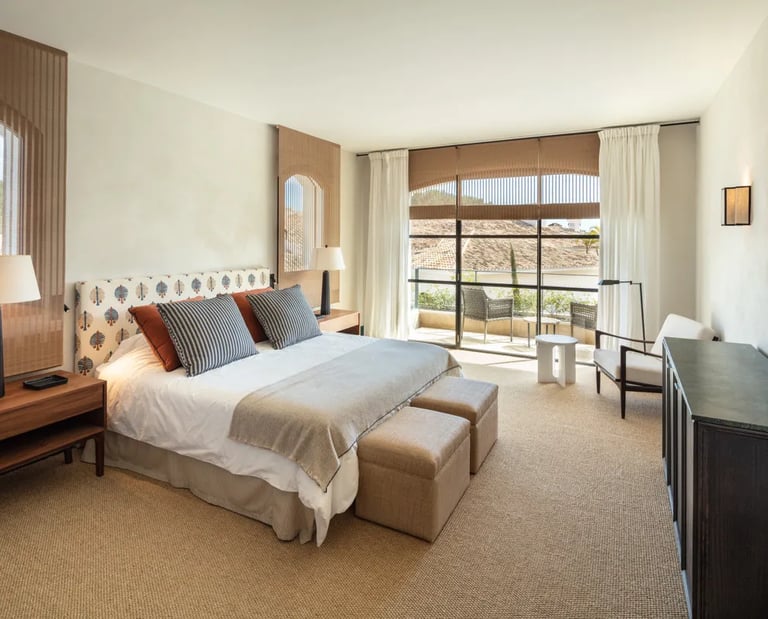 Bedroom at Villa La Gratitud with terrace access and warm tones
