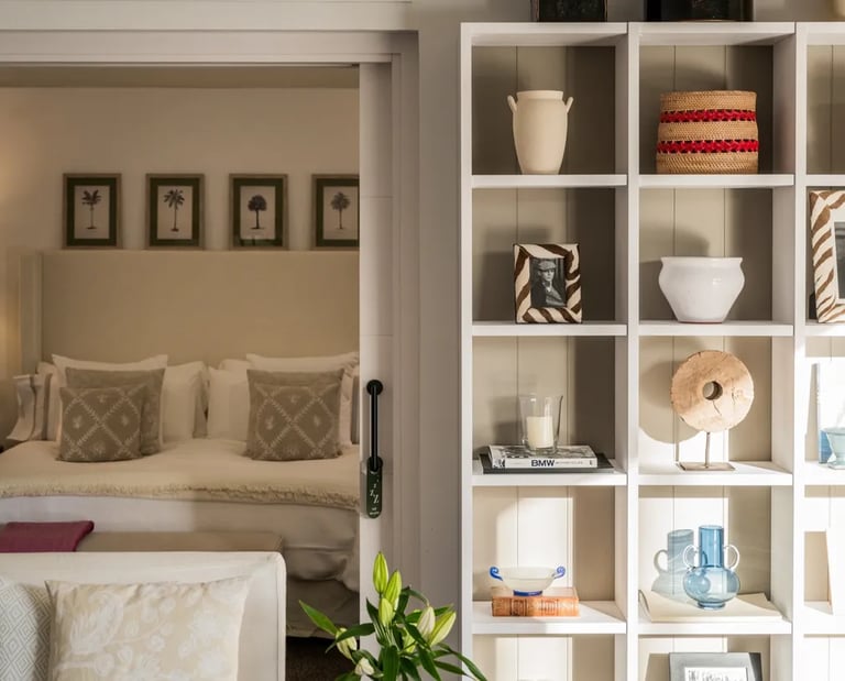 guest suite with soft neutral tones and decorative shelving at Villa El Olivo, Marbella
