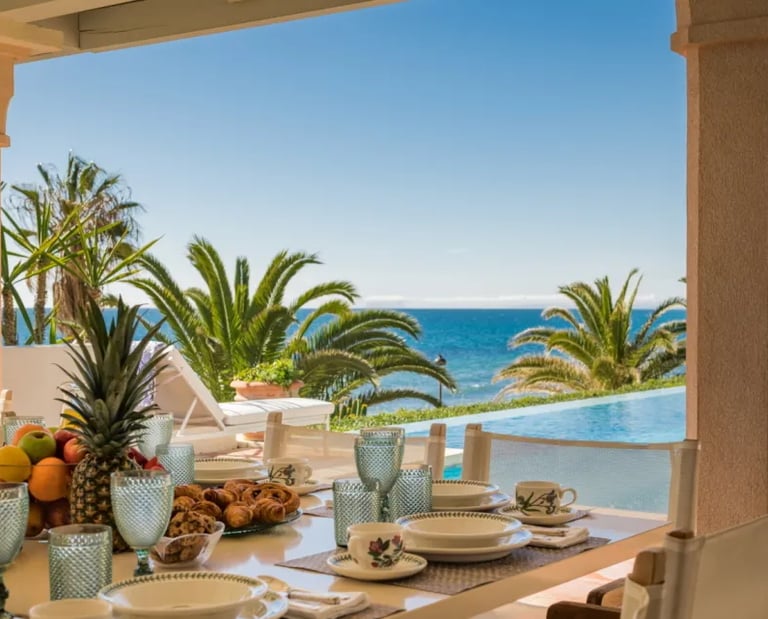 Poolside dining area at Villa El Rincon with sea views