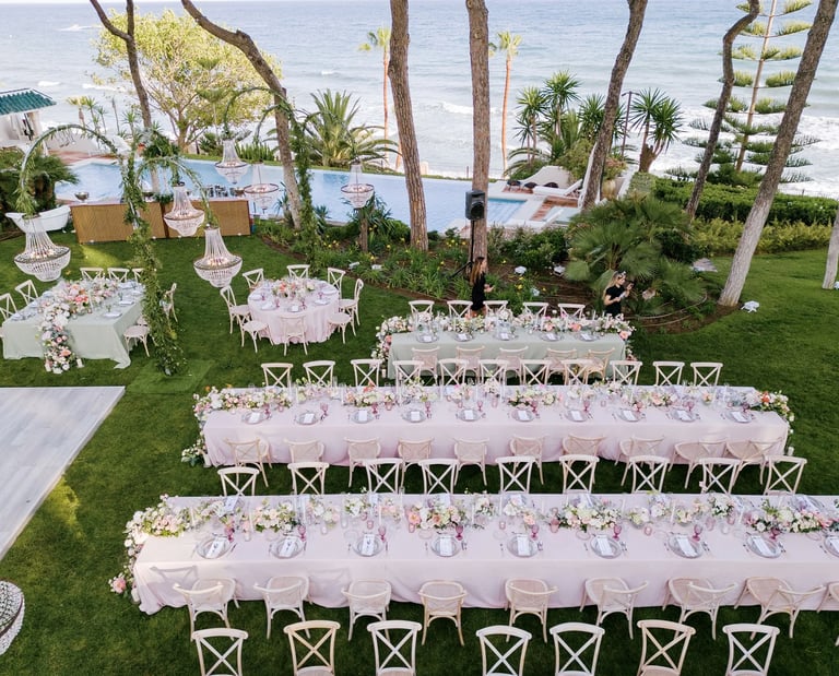 Seafront wedding dinner setup beside infinity pool