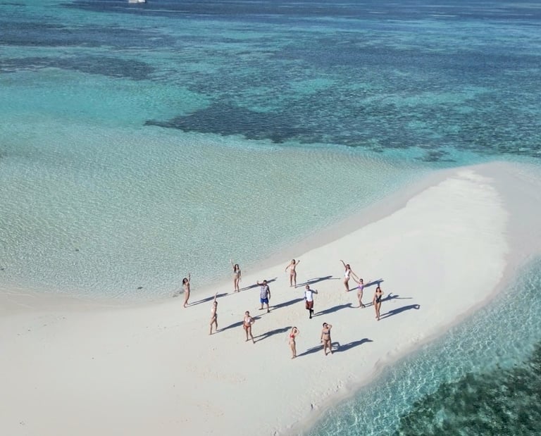Sandbank in the Maldives. With 12 people enjoying their private group time middle of the ocean.