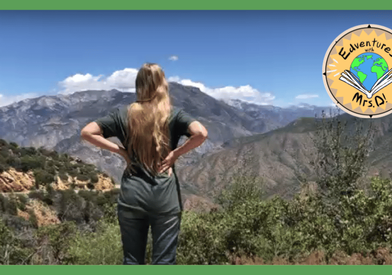 a teacher standing on a mountain top overlooking the valley below
