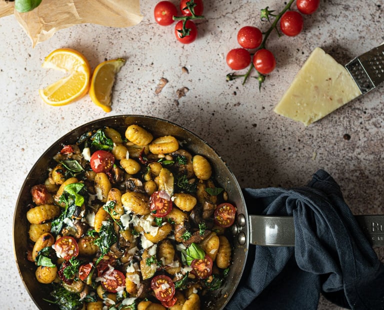 pan of gnocchi, cherry tomatoes, parmesan and basil