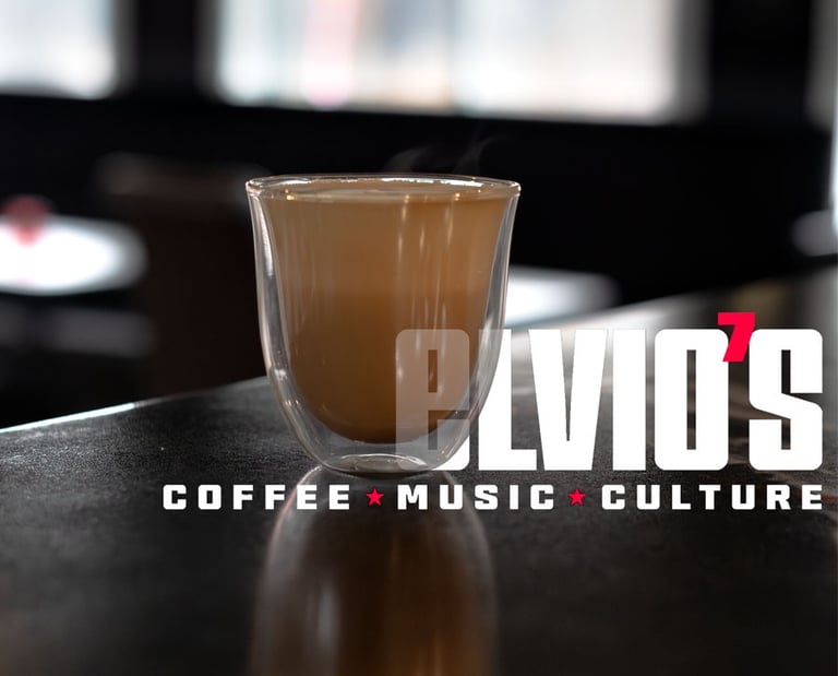 product image of a latte in a clear glass with Elvio's Coffee text in the image
