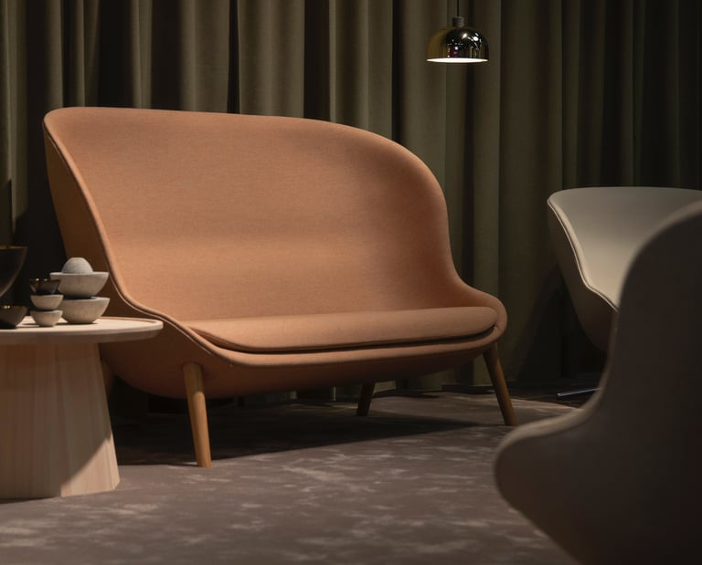 a neutral tone couch with a chair and a table with a lamp earthy tones industrial style decor stone