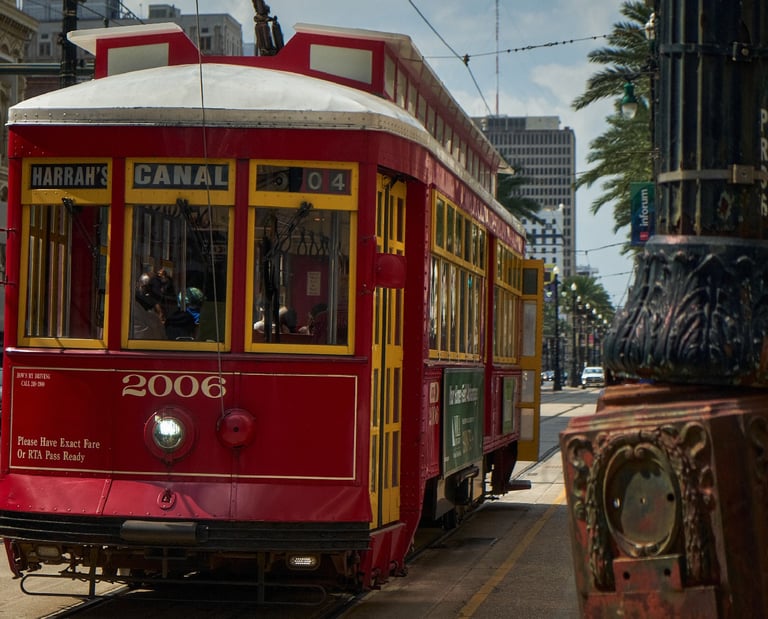 a red trolley car on a city street