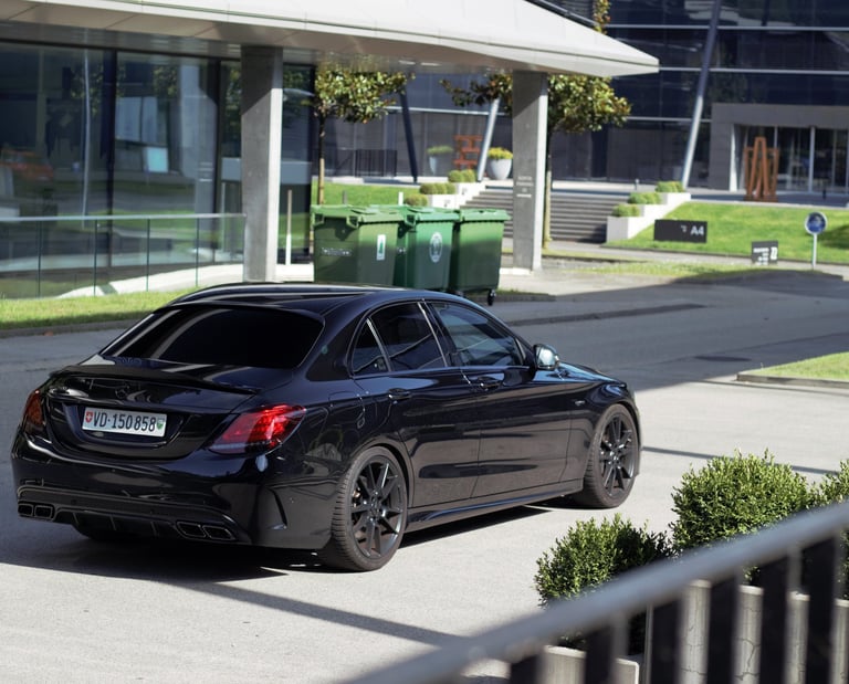 a black car parked on a street corner