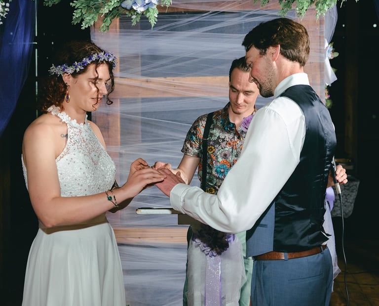 a man and woman getting married and exchanging rings in a wedding ceremony