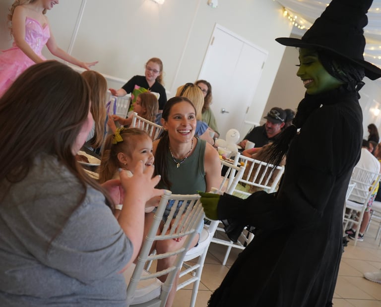 Elphaba talking with guests during a dining experience