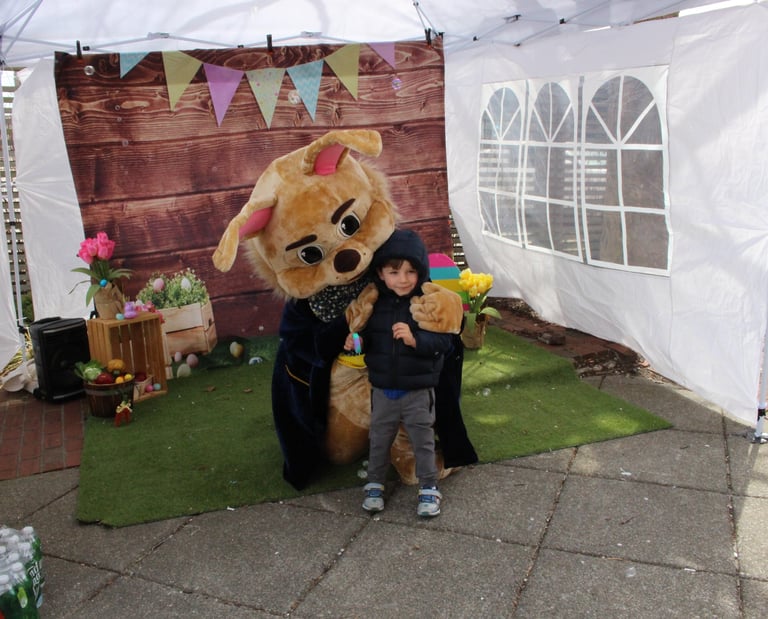 Easter Bunny shares a hug with a kid