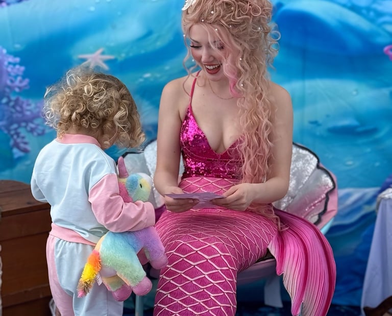 Pink mermaid shares a smile with a kid