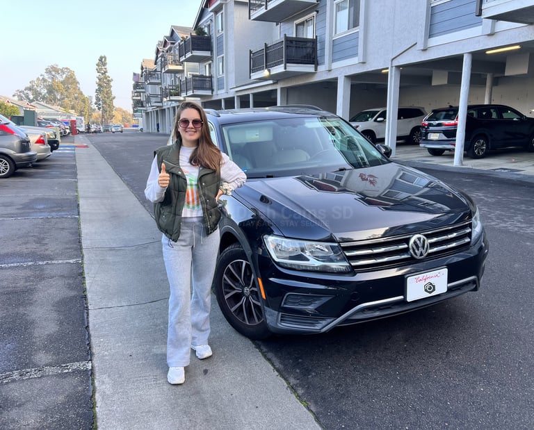 Girl standing in front of volkswagen Tiguan 2019 car