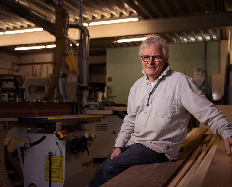 Ein Mann sitzt in der Werkstadt vom Atelier Rohlfs